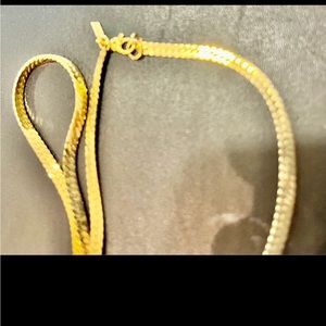 Herringbone chain with  gold tone. Approximately 23 inches.